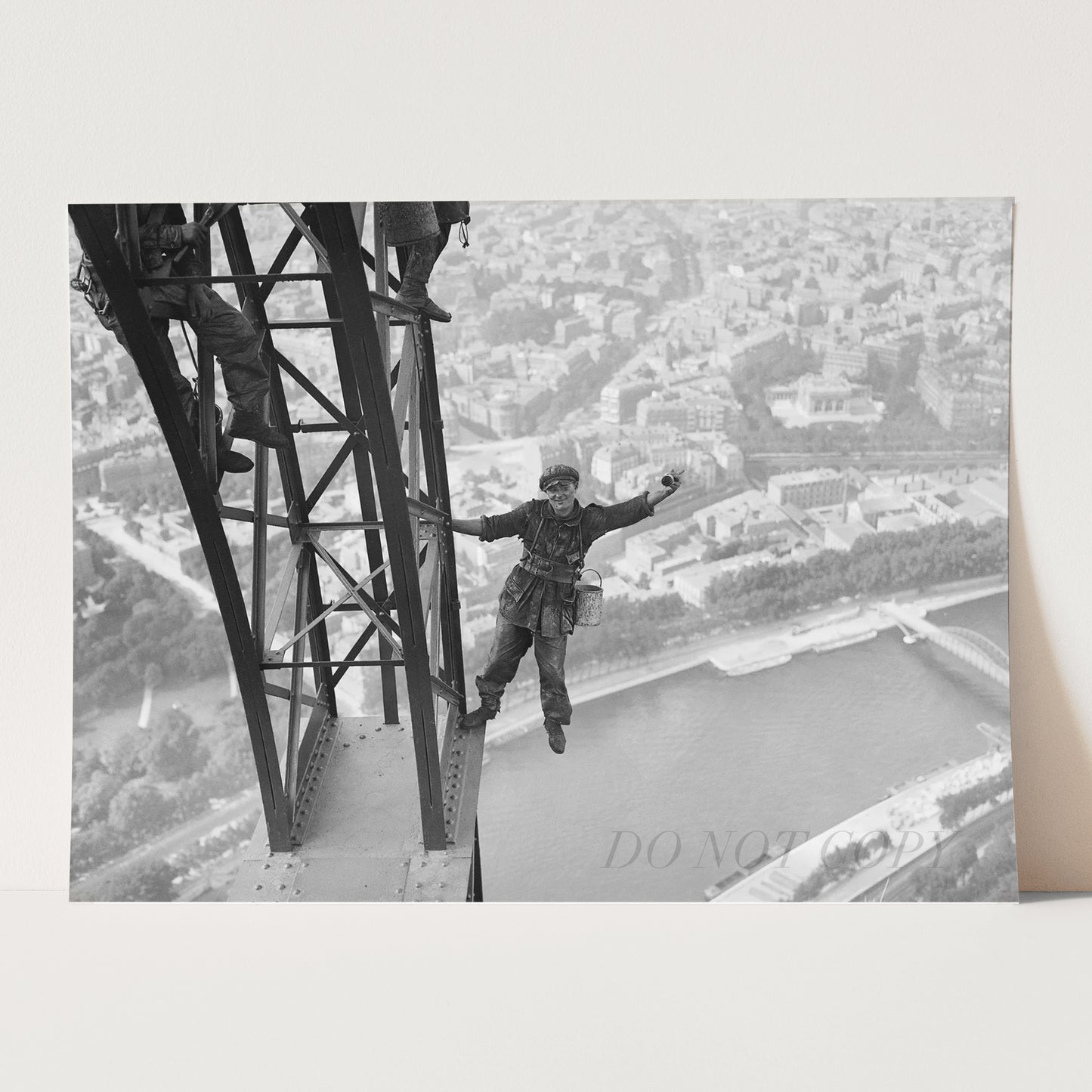 Worker Finishes Painting the Eiffel Tower