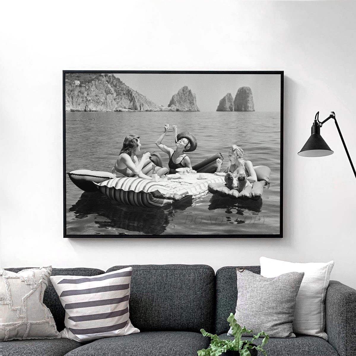 Floating Luncheon, three young women eat spaghetti on inflatable mattresses at Lake of Capri, 1939